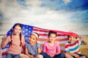 42360702 - children with american flag against serene beach landscape